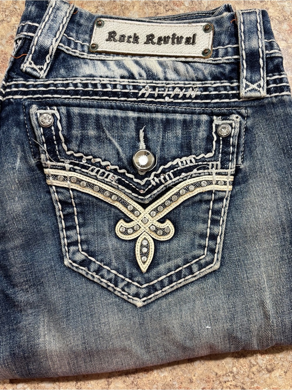 Rock Revival Women’s faded blue Boot cut jeans with rhinestone pockets